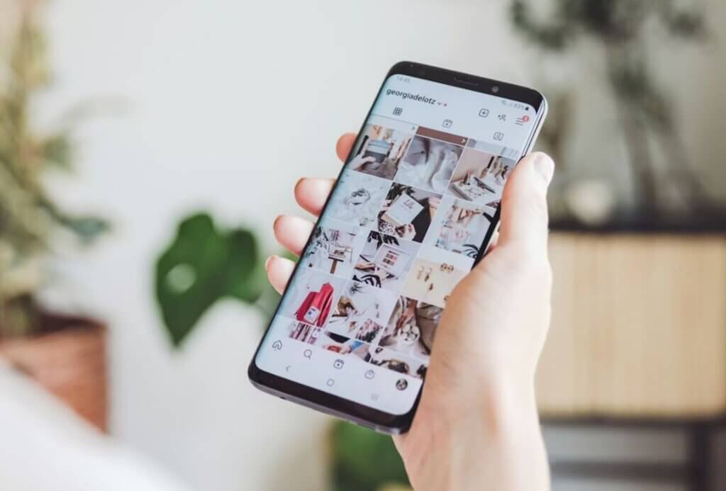 Hand hält Smartphone mit Instagram-Feed